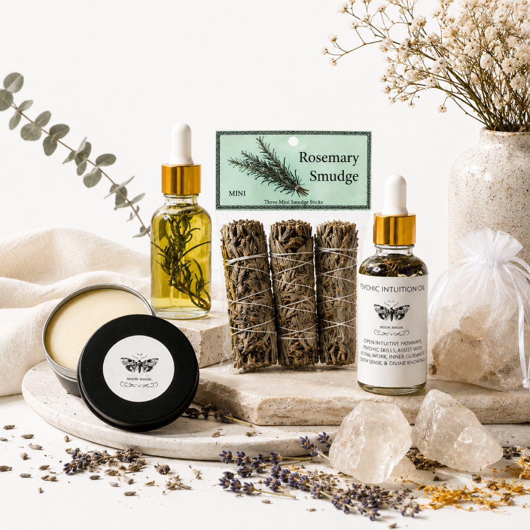 Rosemary smudge bundles, herbal oils, a candle, crystals, and dried flowers arranged in a bright, minimalist setting.